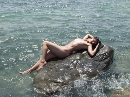Megan takes a stroll by the sea naked